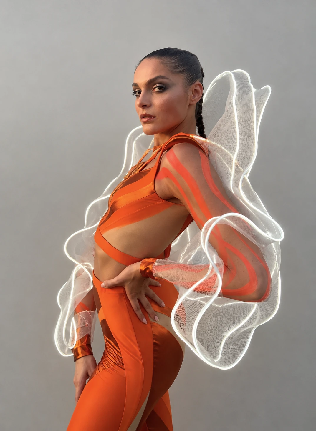 CuteCircuit × Aperol orange outfit with sculptural illuminated mesh wings
