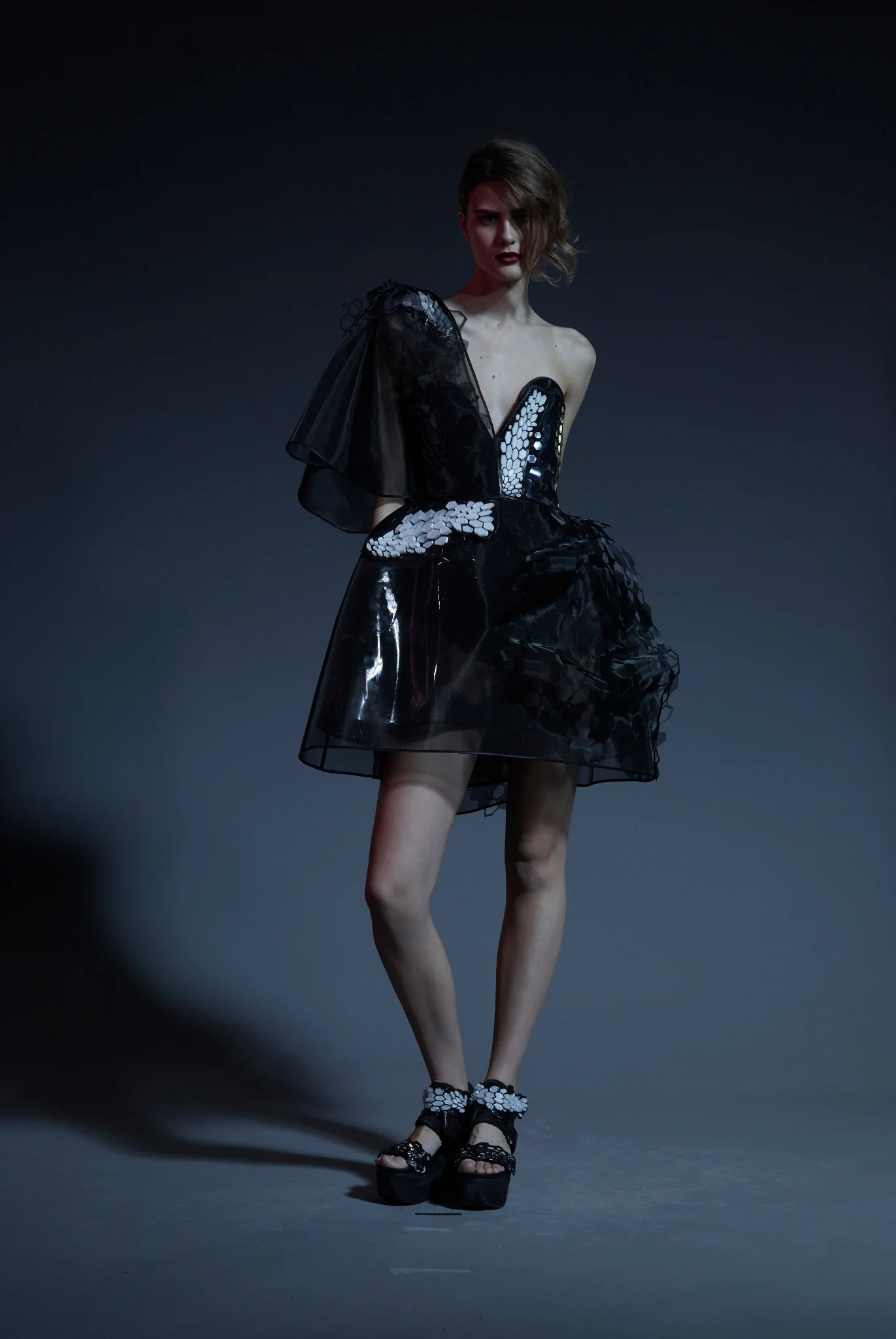 Model wearing the black Graphene Dress with illuminated hexagonal details