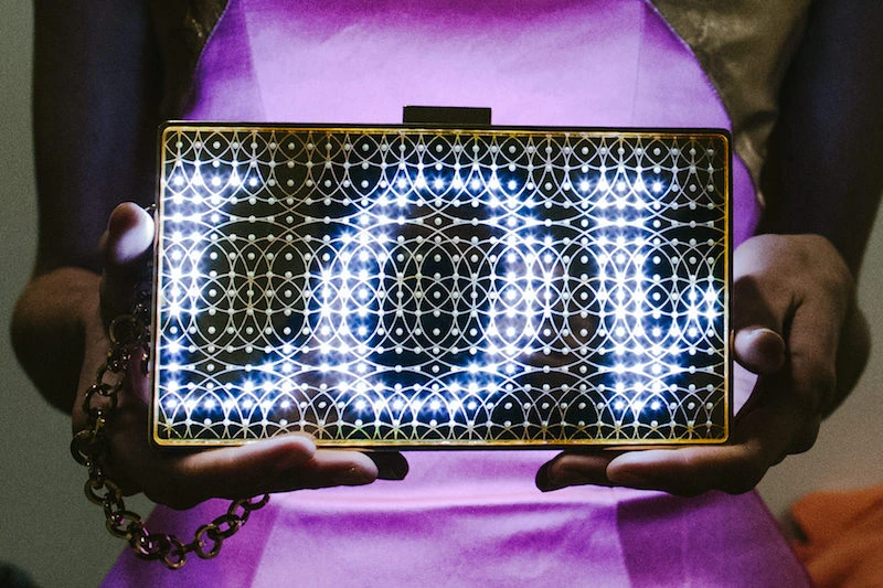 Close-up of an illuminated CuteCircuit handbag held on the Rome anniversary runway