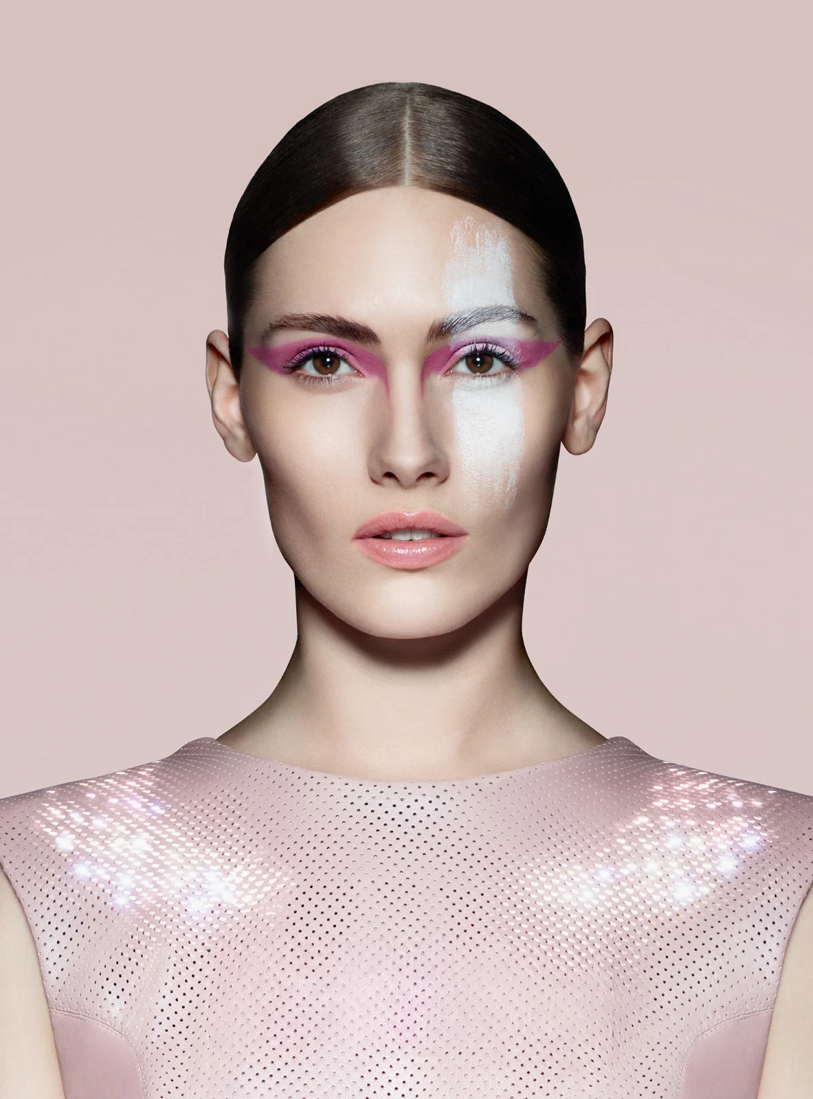 Model wearing a pale pink luminous CuteCircuit top with pink and silver eye makeup.