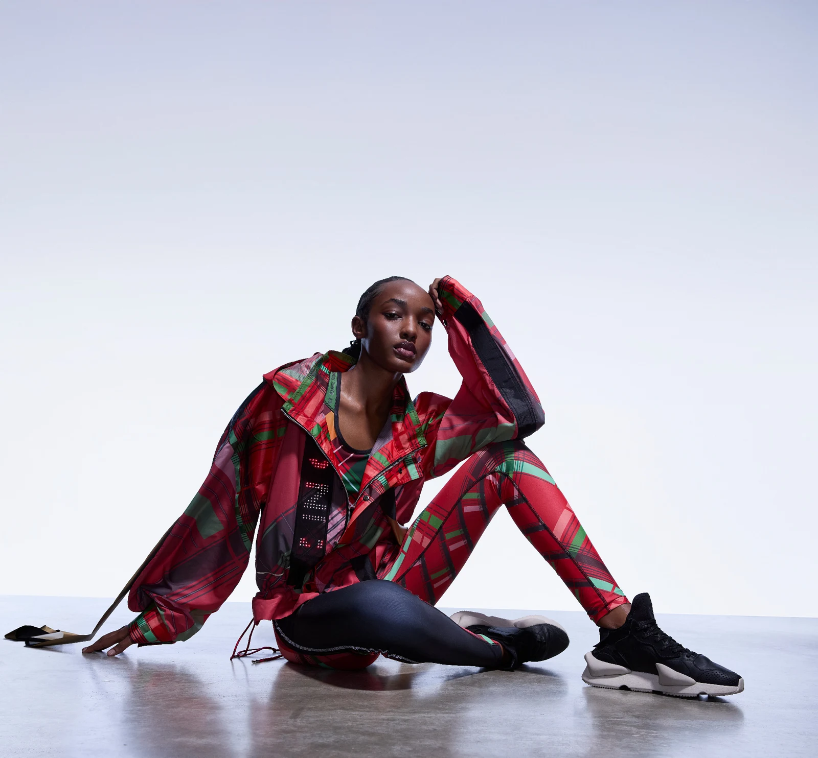 Seated model in the red patterned luminous Kenya Olympic kit by CuteCircuit