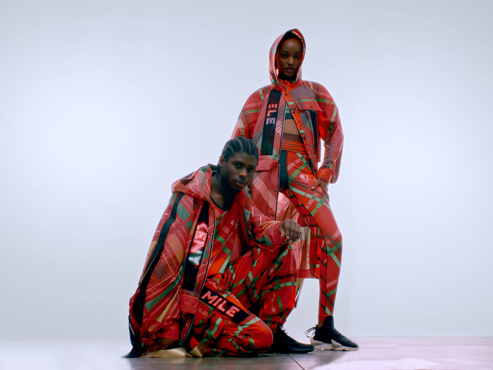 Two models wearing the luminous Kenya Olympic kit by CuteCircuit