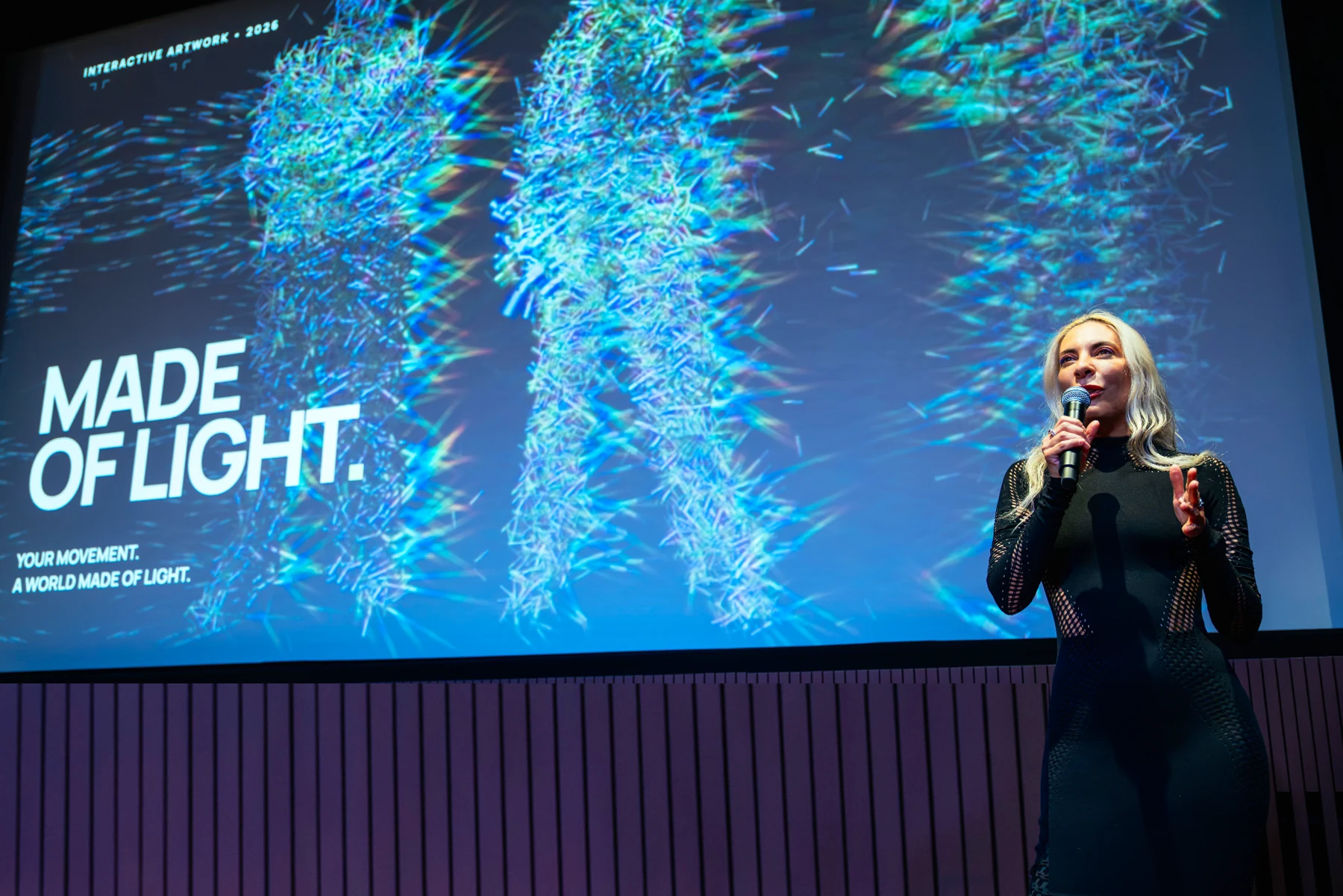 Francesca Rosella presenting Made of Light in front of its colourful interactive figures at Tate Modern