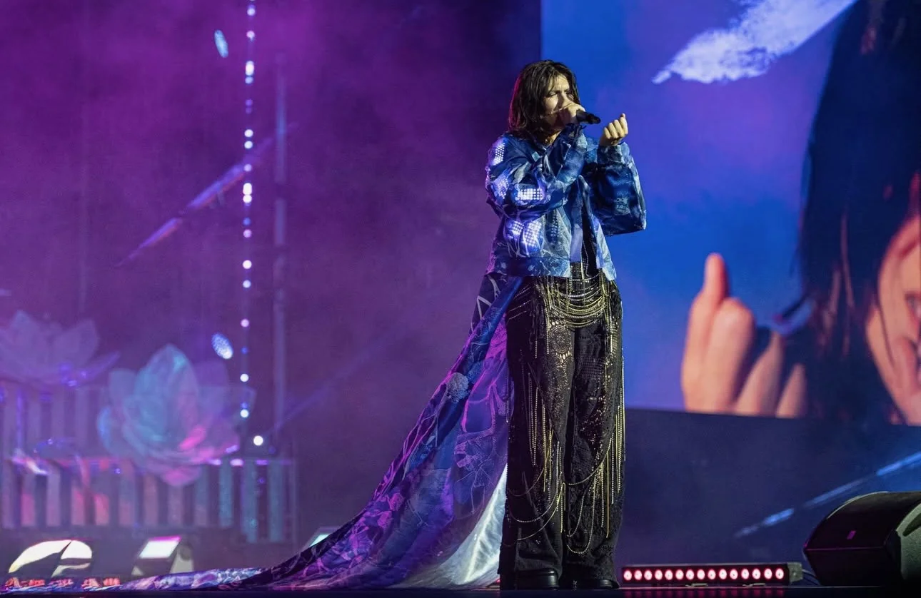 Elisa performing in the illuminated blue CuteCircuit parka