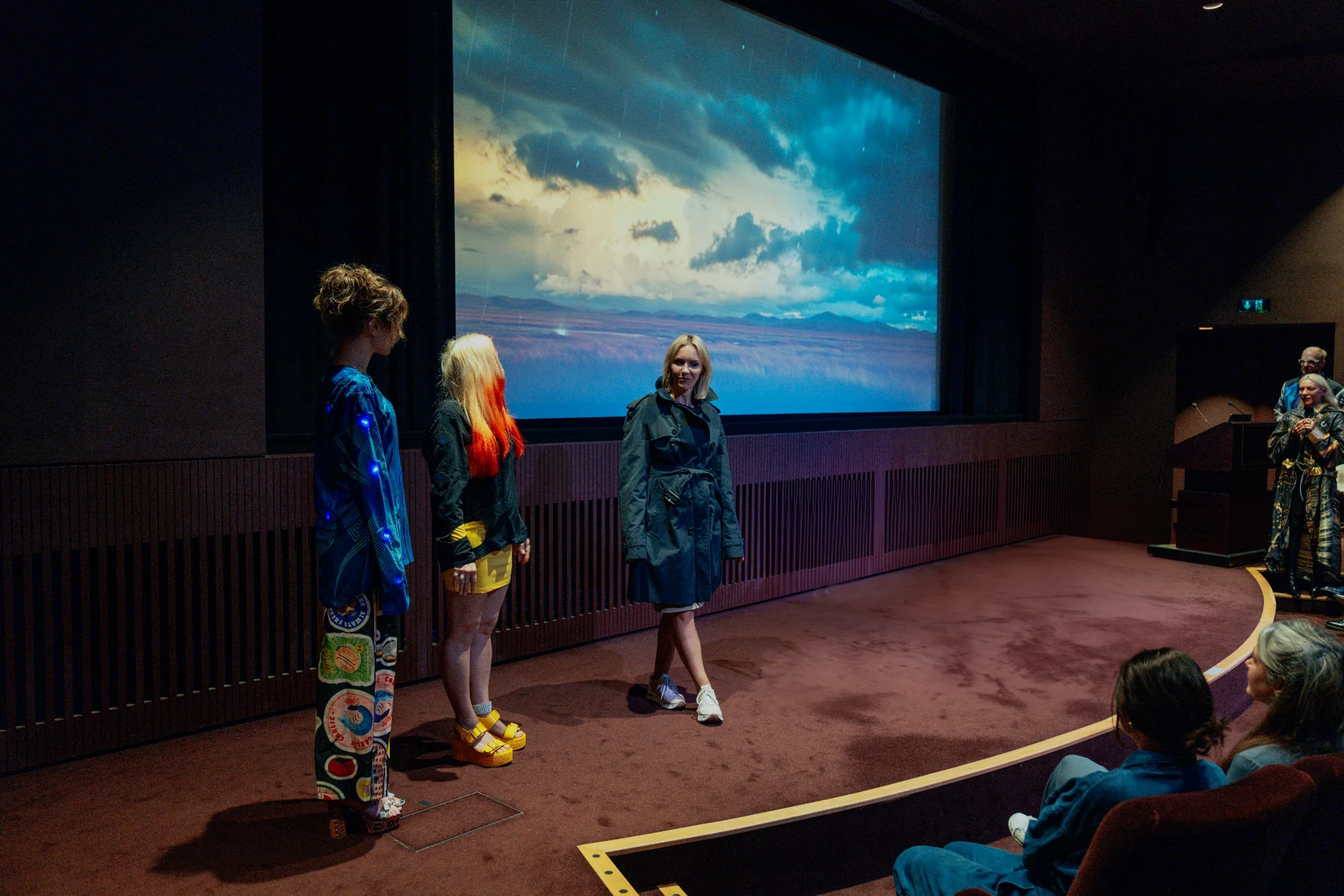 Participants wearing SoundShirts experience The Storm beneath the cinema screen at Tate Modern