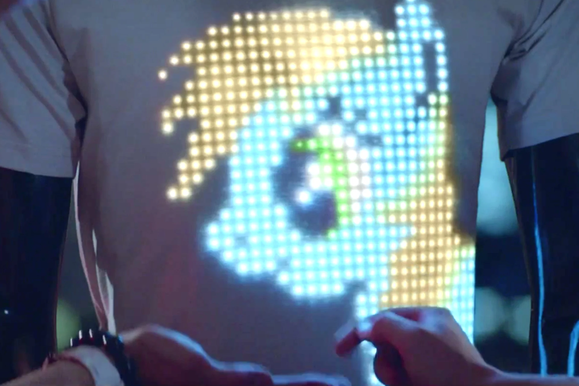 Close-up of the illuminated pixel display on the back of the T-shirt OS